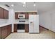 Kitchen with microwave, stove, refrigerator, and laminate counters at 6213 Highland Ave, Leesburg, FL 34748