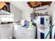 Functional laundry room with washer, dryer, and water heater at 6213 Highland Ave, Leesburg, FL 34748