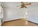 Open living room with laminate floors and a ceiling fan at 6213 Highland Ave, Leesburg, FL 34748