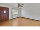 Living room with wood laminate floors, natural light, and classic trim at 6213 Highland Ave, Leesburg, FL 34748