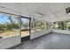 Enclosed porch with views of the backyard and natural light at 6213 Highland Ave, Leesburg, FL 34748
