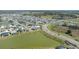 Aerial view of the community featuring ponds, roads, and multiple houses at 7163 Jerry Ave, The Villages, FL 34762