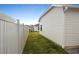 Narrow backyard space featuring a grassy lawn and white vinyl fencing at 7163 Jerry Ave, The Villages, FL 34762