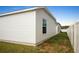 Side view of the backyard featuring a grassy lawn and white vinyl fence at 7163 Jerry Ave, The Villages, FL 34762