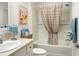 Bathroom featuring a shower and tub, light-colored tile and neutral walls and countertop at 7163 Jerry Ave, The Villages, FL 34762