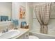 Bathroom featuring a shower and tub, light-colored tile and neutral walls and countertop at 7163 Jerry Ave, The Villages, FL 34762