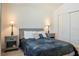 Inviting bedroom featuring a comfortable bed, matching bedside tables with lamps, and ample closet space at 7163 Jerry Ave, The Villages, FL 34762