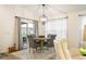 Cozy dining room with a round table, comfortable gray chairs, and natural light from the sliding glass door at 7163 Jerry Ave, The Villages, FL 34762