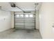 Spacious garage with a sealed concrete floor and a white metal garage door at 7163 Jerry Ave, The Villages, FL 34762