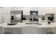 Bright kitchen with white cabinetry, stainless steel appliances, and a stylish backsplash at 7163 Jerry Ave, The Villages, FL 34762
