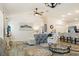 Open-concept living space with a ceiling fan, dining area, and kitchen in a bright and airy design at 7163 Jerry Ave, The Villages, FL 34762