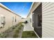 Side yard with minimal landscaping and patio seating visible off the screened-in porch at 7163 Jerry Ave, The Villages, FL 34762