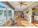 Bright living room featuring wood floors, large windows, and neutral decor at 720 Camino Del Rey Dr, The Villages, FL 32159