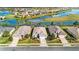 Beautiful aerial view of homes in a waterfront community with landscaped yards and serene water views at 8780 Bridgeport Bay Cir, Mount Dora, FL 32757