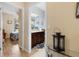 Hallway view into bathroom featuring a granite countertop, cabinets, and decorative mirror at 8780 Bridgeport Bay Cir, Mount Dora, FL 32757