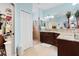 Spacious bathroom with a large vanity, granite countertops, walk-in shower, and ample storage space at 8780 Bridgeport Bay Cir, Mount Dora, FL 32757