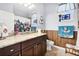 Bathroom features granite counters, dark wood cabinets, and a decorative butterfly shower curtain at 8780 Bridgeport Bay Cir, Mount Dora, FL 32757