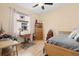 Bedroom with a large window bringing in natural light, complete with a ceiling fan and hardwood flooring at 8780 Bridgeport Bay Cir, Mount Dora, FL 32757