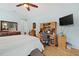 Comfortable bedroom setup including a desk, chair, TV, and closet, creating a multi-functional and cozy living space at 8780 Bridgeport Bay Cir, Mount Dora, FL 32757