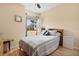 Bedroom with hardwood floors, cozy bed, and ample natural light creating a comfortable and inviting space in the home at 8780 Bridgeport Bay Cir, Mount Dora, FL 32757