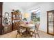 Charming dining room featuring a round table, wooden chairs, and a decorative hutch at 8780 Bridgeport Bay Cir, Mount Dora, FL 32757