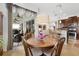 Cozy dining area with a round table, wooden chairs, and sliding glass doors to the lanai at 8780 Bridgeport Bay Cir, Mount Dora, FL 32757
