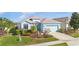 Charming single-story home with well-manicured lawn, two car garage, and tasteful landscaping at 8780 Bridgeport Bay Cir, Mount Dora, FL 32757
