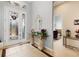 Inviting foyer with tile flooring, decorative lighting and a stylish glass front door at 8780 Bridgeport Bay Cir, Mount Dora, FL 32757