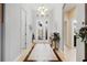 Inviting foyer with tile flooring, decorative lighting and a stylish glass front door at 8780 Bridgeport Bay Cir, Mount Dora, FL 32757