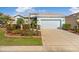 Charming single Gathering home featuring beautiful landscaping, stone accents and a two car garage at 8780 Bridgeport Bay Cir, Mount Dora, FL 32757