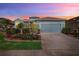 Charming single Gathering home featuring beautiful landscaping, stone accents and a two car garage at 8780 Bridgeport Bay Cir, Mount Dora, FL 32757