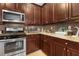 Well-equipped kitchen with stainless steel appliances, granite counters, and ample cabinet space at 8780 Bridgeport Bay Cir, Mount Dora, FL 32757