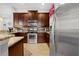 Updated kitchen showcasing stainless steel appliances, granite countertops, and stylish dark cabinets at 8780 Bridgeport Bay Cir, Mount Dora, FL 32757