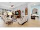 Bright living room features tile floors, ceiling fan, large windows, and comfortable seating at 8780 Bridgeport Bay Cir, Mount Dora, FL 32757
