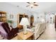 Cozy living room showcasing tile floors, a ceiling fan, and comfortable seating arrangements at 8780 Bridgeport Bay Cir, Mount Dora, FL 32757