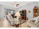 Inviting living room with tile floors, ceiling fan, and sliding glass doors leading to outdoor space at 8780 Bridgeport Bay Cir, Mount Dora, FL 32757