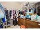 Spacious walk-in closet featuring shelving and rod system for storage, a dresser, and a small floor safe for securing items at 8780 Bridgeport Bay Cir, Mount Dora, FL 32757