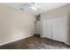 Bedroom features a ceiling fan, polished concrete floor, and closet with bifold doors at 9825 Sandy Pines Rd, Clermont, FL 34711