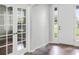 Bright foyer area featuring white paneled entry door and an interior French door with glass panes at 9825 Sandy Pines Rd, Clermont, FL 34711