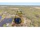 Expansive aerial view of property with pond, mature trees, and a long driveway leading to the main residence at 2600 Robie Ave, Mount Dora, FL 32757