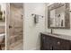 Clean bathroom showcasing a walk-in shower and a vanity with marble top at 2600 Robie Ave, Mount Dora, FL 32757