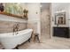 Bright bathroom featuring a clawfoot tub, walk-in shower, and stylish vanity at 2600 Robie Ave, Mount Dora, FL 32757