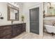 Classic bathroom includes a vanity with marble top and an elegant clawfoot tub at 2600 Robie Ave, Mount Dora, FL 32757