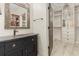 Charming bathroom features an ornate mirror, granite countertop and dark wood vanity at 2600 Robie Ave, Mount Dora, FL 32757