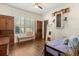 Well-lit bedroom featuring hardwood floors, a window bench, and decorative furnishings at 2600 Robie Ave, Mount Dora, FL 32757