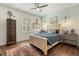 Comfortable bedroom with hardwood floors, a decorative wood cabinet, and a queen-sized bed at 2600 Robie Ave, Mount Dora, FL 32757