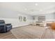 Spacious bonus room with a plush recliner, natural light, and versatile shelving units at 2600 Robie Ave, Mount Dora, FL 32757