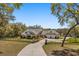 Beautiful home exterior featuring a gated entrance, well-manicured lawn, and a long driveway leading to a three car garage at 2600 Robie Ave, Mount Dora, FL 32757