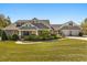 Beautifully landscaped home with a manicured lawn, mature shrubbery, and a welcoming front porch at 2600 Robie Ave, Mount Dora, FL 32757
