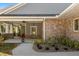 Covered porch featuring brick accents, ceiling fans, and comfortable seating for outdoor enjoyment at 2600 Robie Ave, Mount Dora, FL 32757